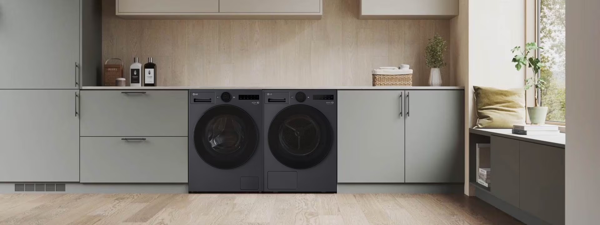 Bộ máy giặt và máy sấy LG cửa trước màu đen đặt cạnh nhau trong tủ bếp hiện đại